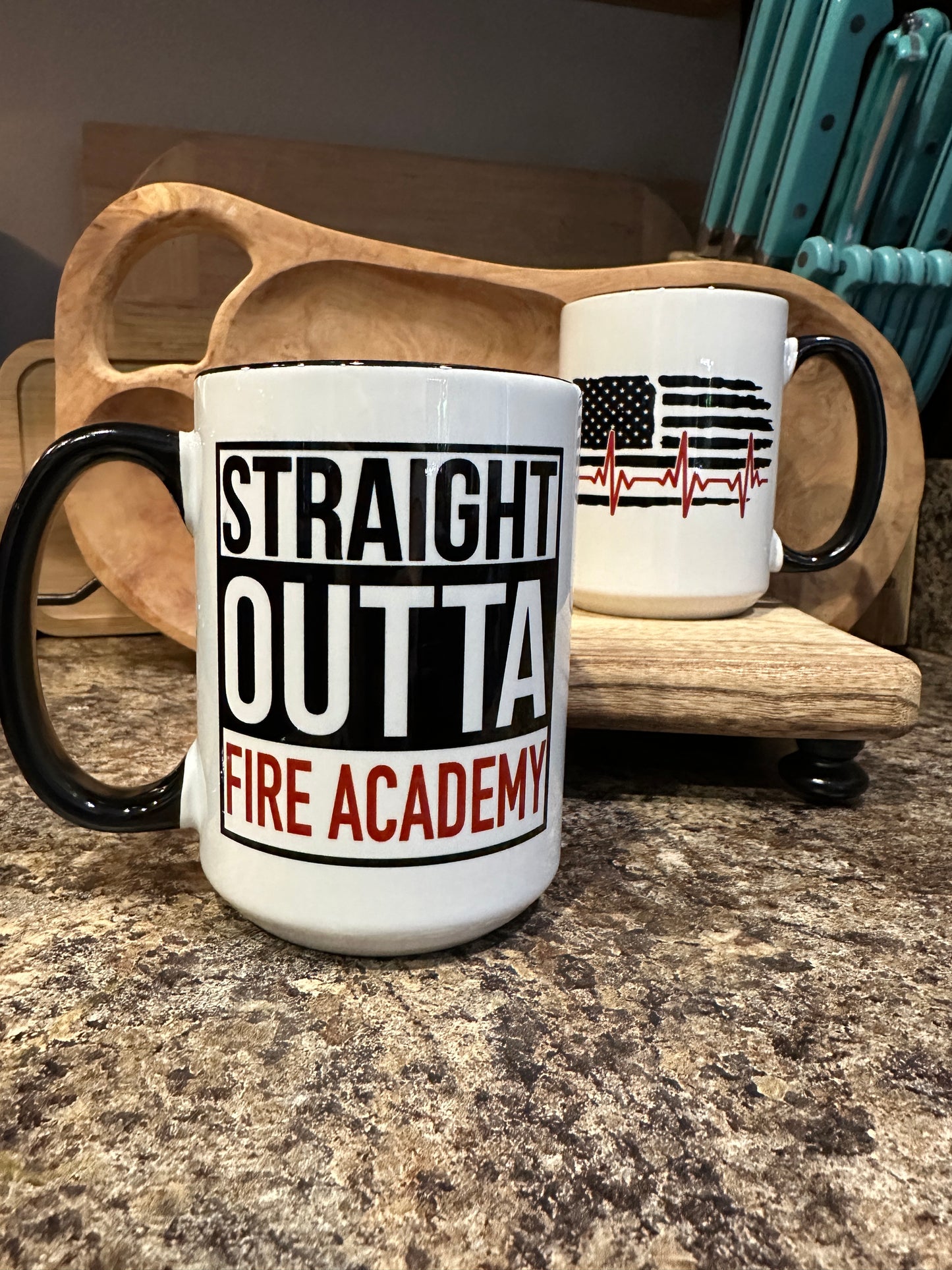 Black handle Mug, front graphic black and white cut out letters that read "straight outta fire academy". Back image is the tattered flag with the red line heart beat